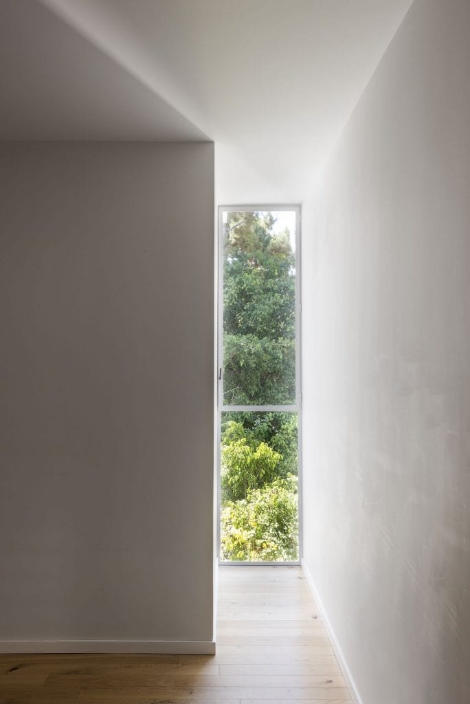 Narrow Belgian window with insulating glass and white iron profile. Thermal window