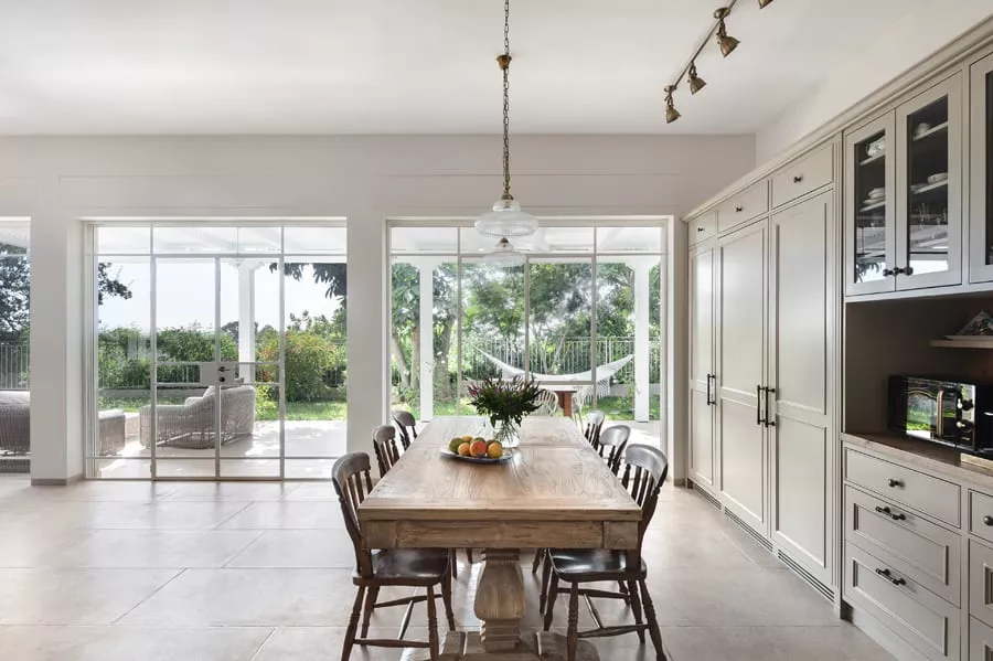 White Steel Windows and Doors with Roller-Shutters Minimalist Hot-Rolled Steel-Profiles. Sun Protection, Darkening, and Privacy using external Roller-Shutters.